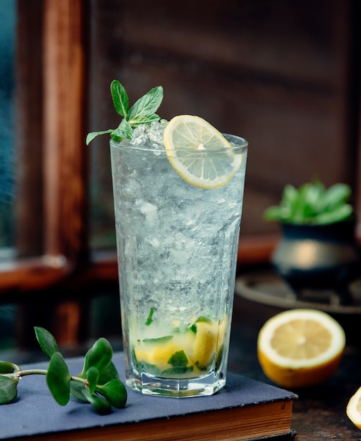 Foto gratuita un primo piano del bicchiere di mojito con limone e trucioli di ghiaccio