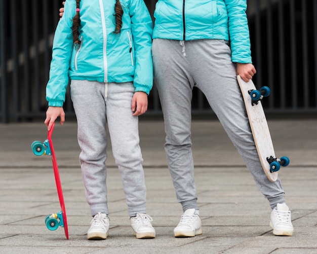 Close-up mom and daughter with skateboard