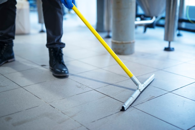 Close up of mop cleaning industrial plant floor