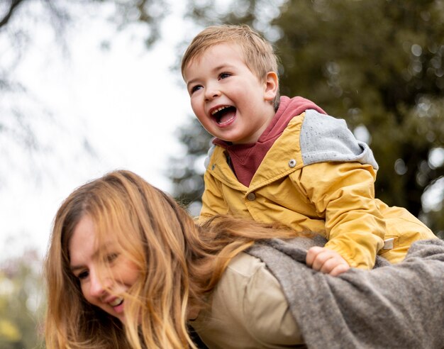 Close-up mother carrying son