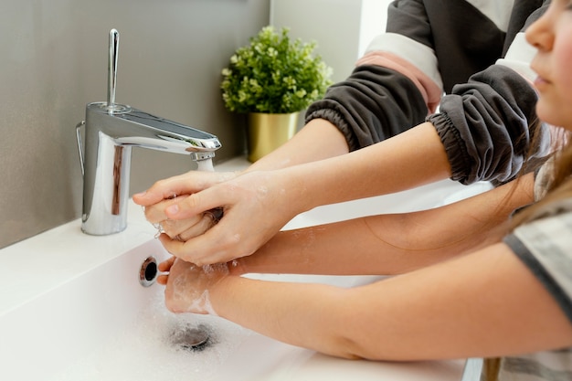 Close up mother and child washing hands