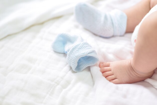 Close-up of mother hands holding tiny baby feet