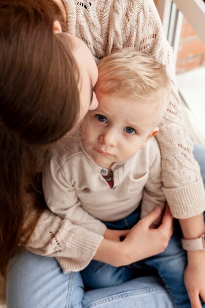 Close-up mother kissing son