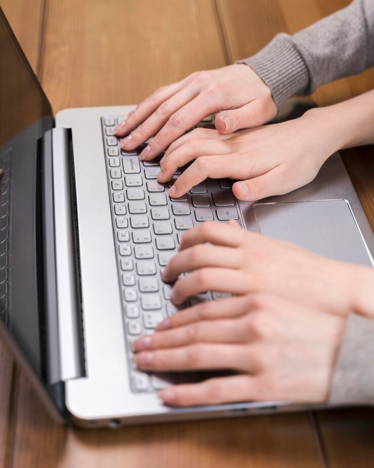 Free Photo close-up mother teaching her son how to use laptop