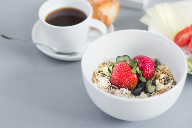 Close-up of muesli bowl and breakfast plates
