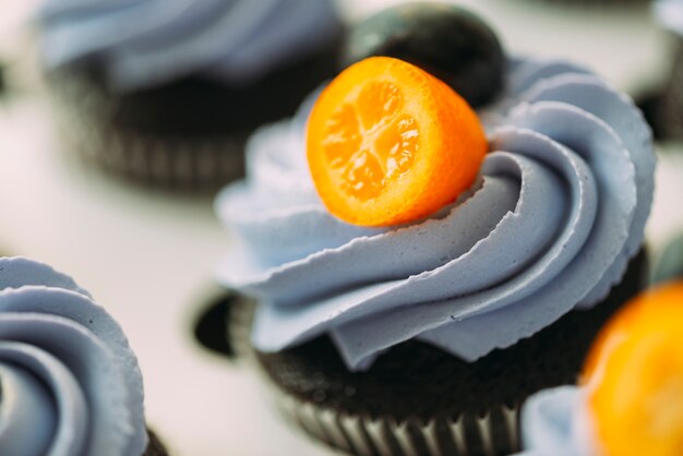 Close-up muffin with cream and fruits