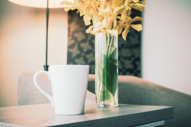 Close-up of mug next to a vase