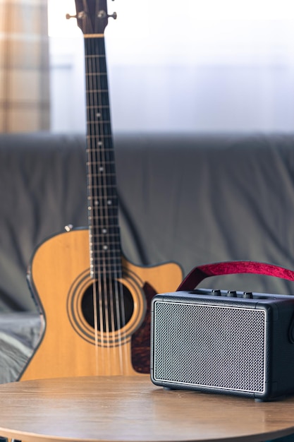 Close up music speaker and acoustic guitar in the interior of the room