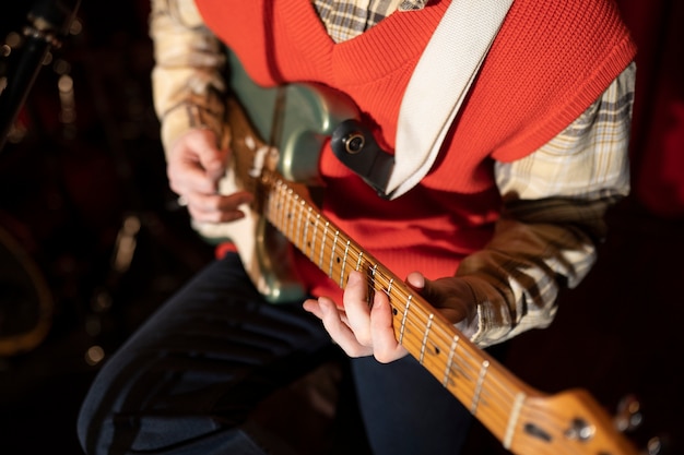 Close up musician playing guitar