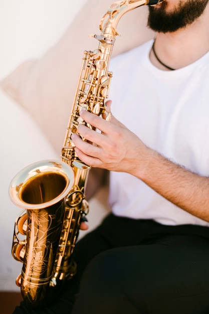 Close up musician playing saxophone