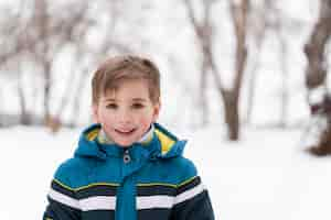 Free photo close up n happy kid playing in the snow