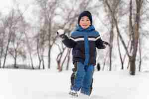 Free photo close up n happy kid playing in the snow