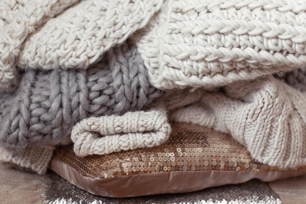 Close up of neatly folded knitted items of pastel color