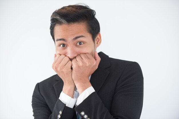 Close-up of nervous businessman biting nails