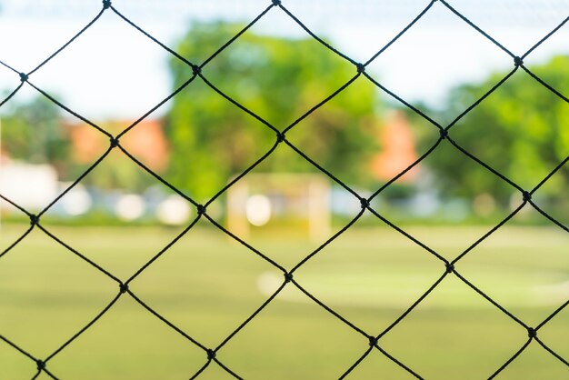 close-up net with soccer field background