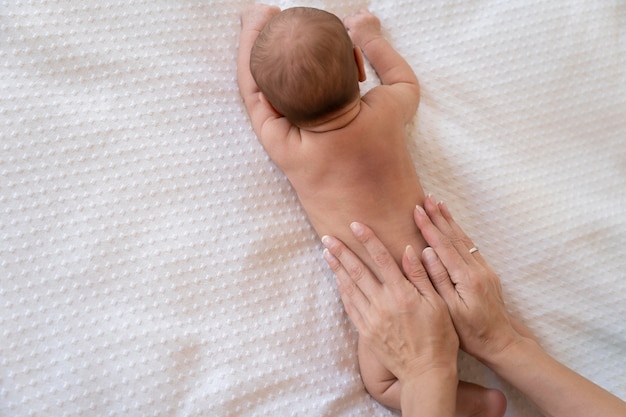 The picture of mother applying lotion on baby skin to stay hydrated.