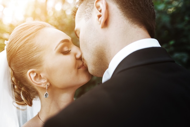 Close-up of newlyweds in love kissing