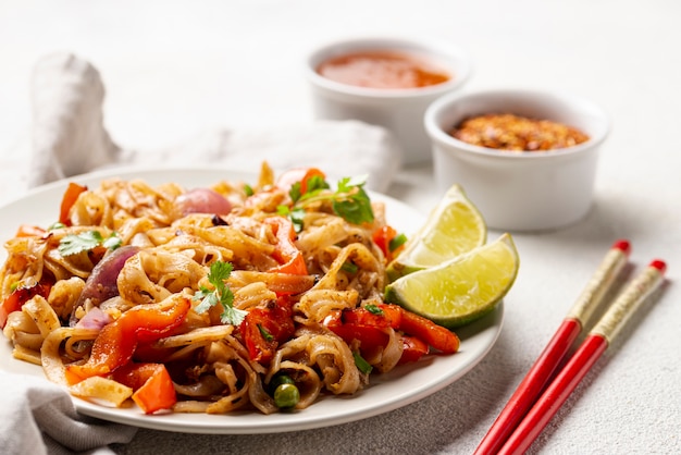 Close-up noodles with vegetables and chopsticks