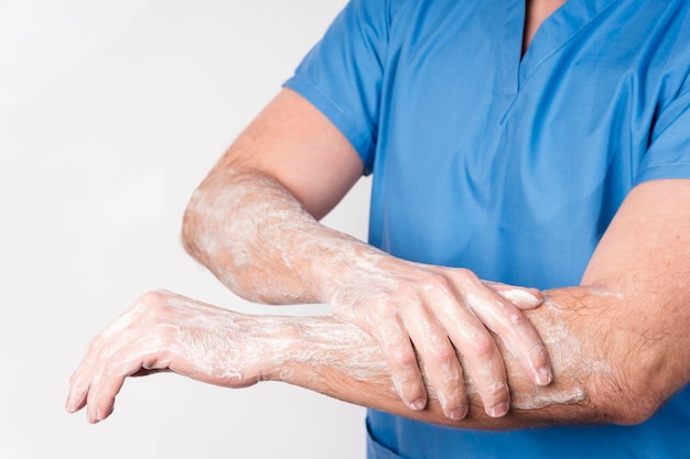 Close-up nurse disinfecting hands