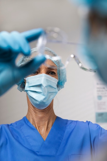 Close up nurse holding glasses