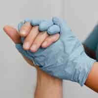 Free photo close up nurse holding patient's hand