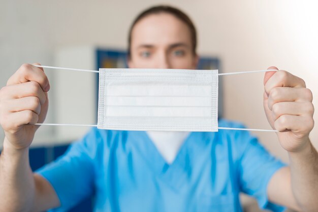 Close-up nurse showing medical mask