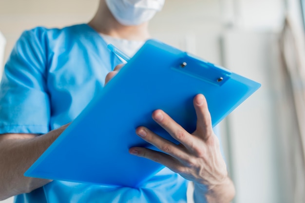 Close-up nurse with clipboard