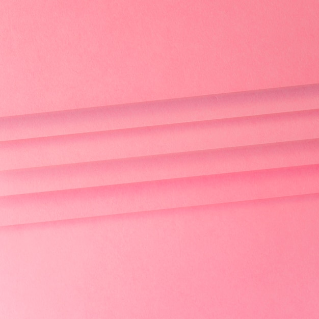Бесплатное фото Крупный план линий на розовой бумаге текстурированный фон