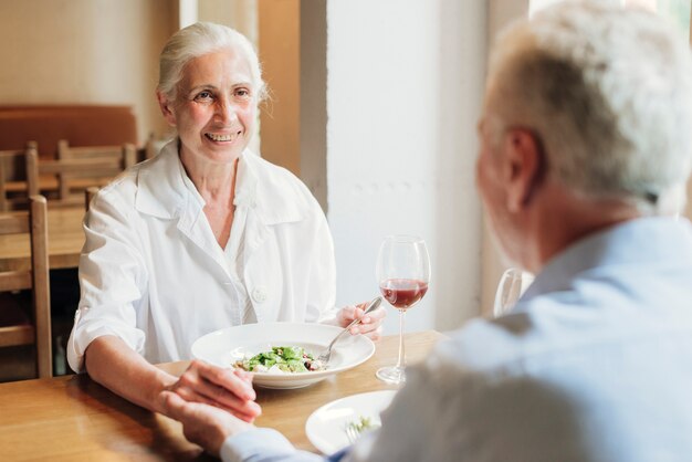 Close-up old couple eating together