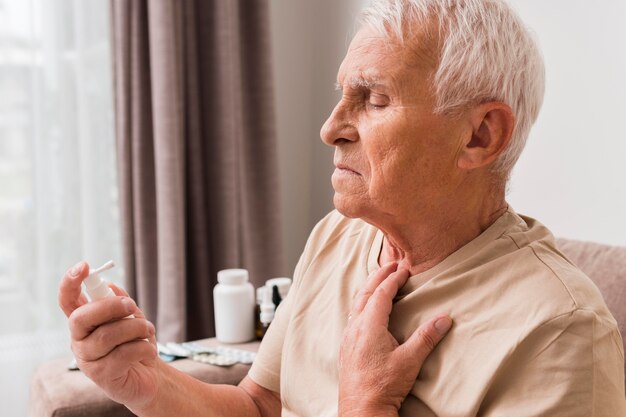 Close-up old man with oral spray