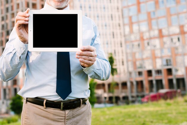 Close-up old man with tablet mock-up