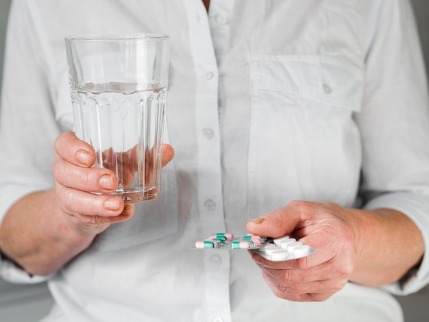 Close-up old patient with pills