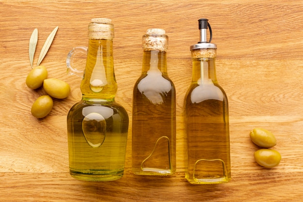 Close up olive bottles yellow olives and leaves