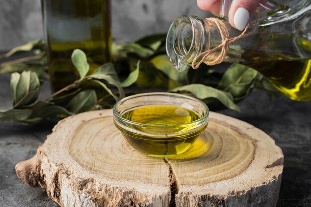 Close-up olive oil pouring into bowl