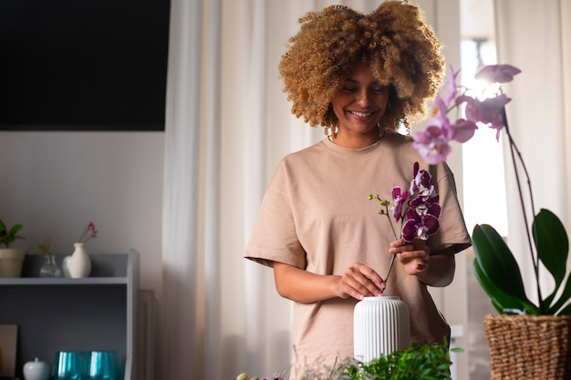 Бесплатное фото Крупным планом женщина украшает свой дом орхидеями