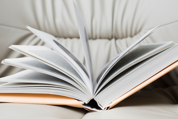 Close-up of open book on armchair