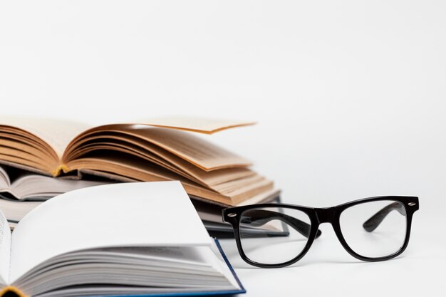 Close-up open books with glasses