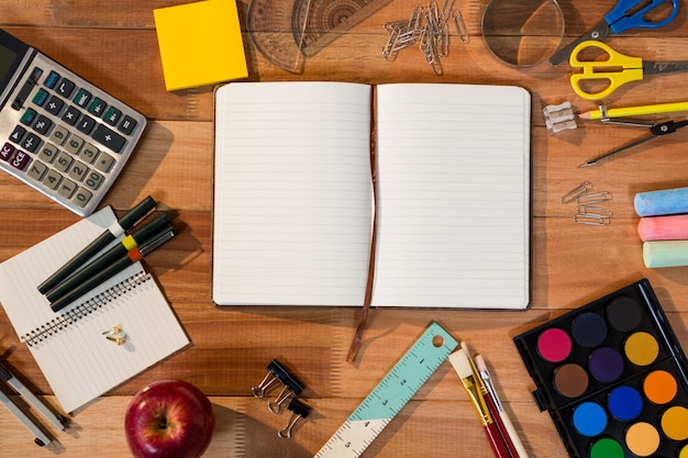 Close-up of open diary with various stationery