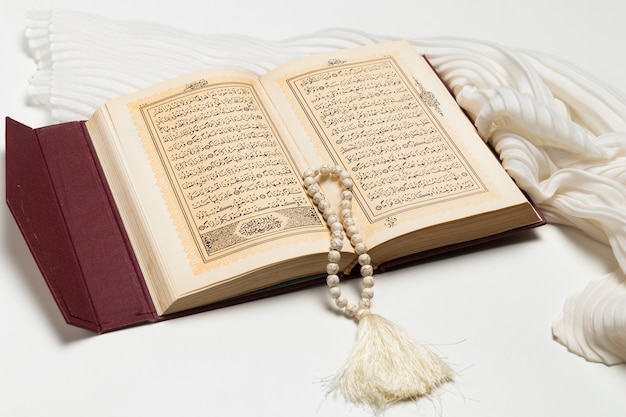 Close-up open holy book with bracelet