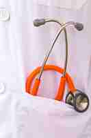 Free photo close-up of orange stethoscope in a pocket