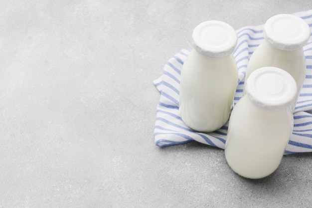 Close-up organic milk bottles with copy space