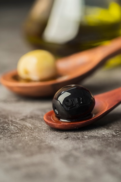 Close-up organic olives in a spoon