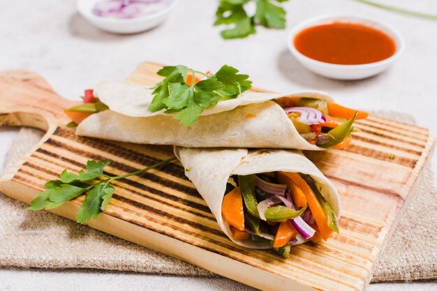 Close-up of organic vegetables wrapped in pita with sauce