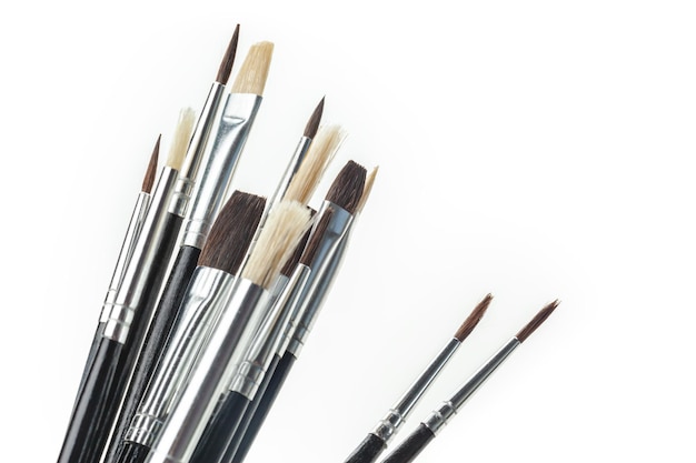 Close up of paint brushes on white background