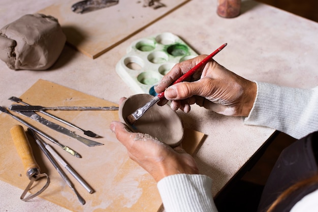 Close-up painting pottery pot