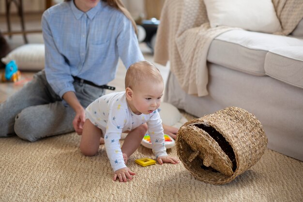 Close up parent holding baby crawling