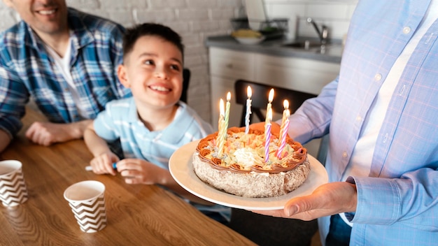 Close up parent holding cake