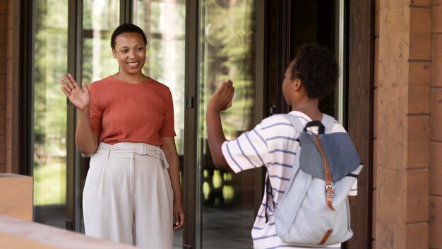 Close up on parent preparing her child for school