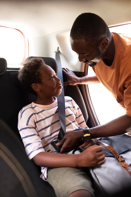 Close up on parent securing son safety belt