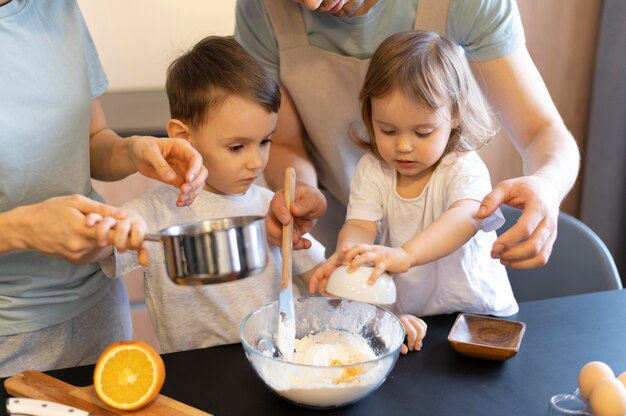 Close-up parents and kids making dough